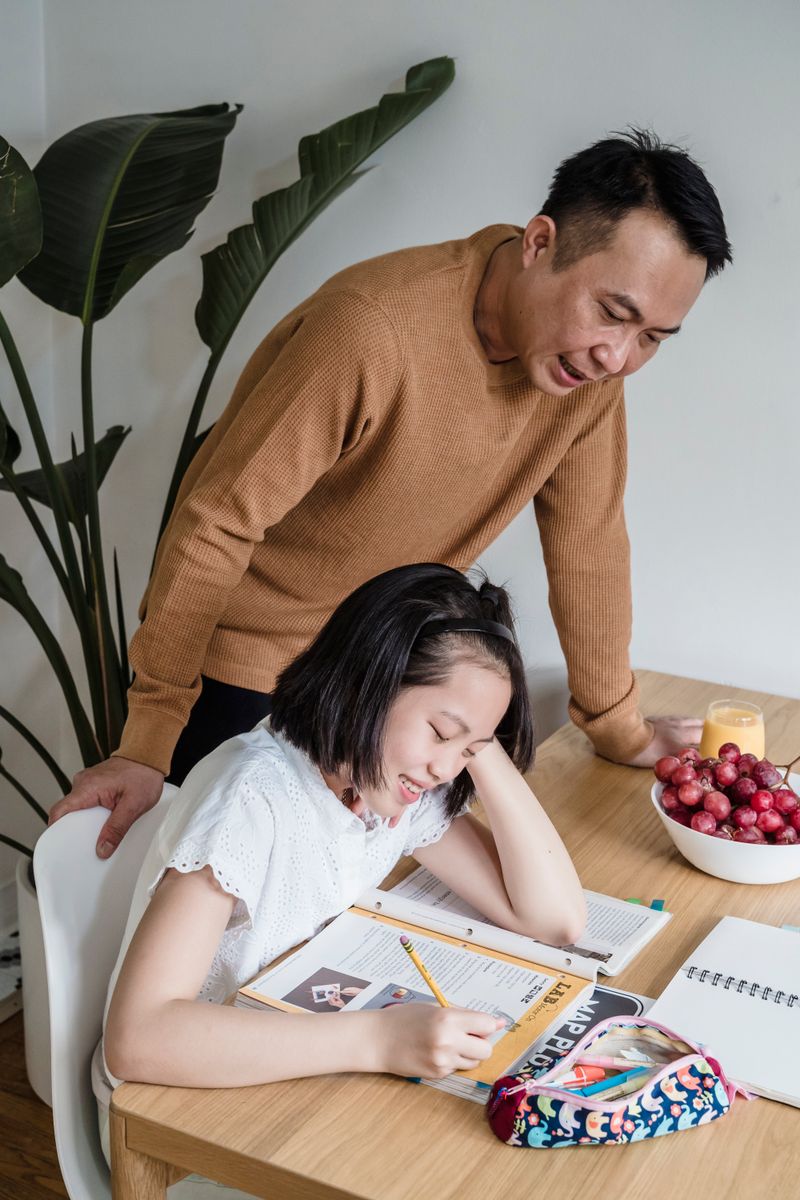 A parent and child studying together at home