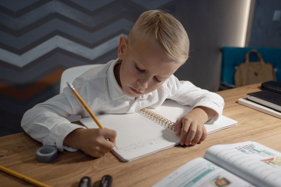 A child writing in a school notebook